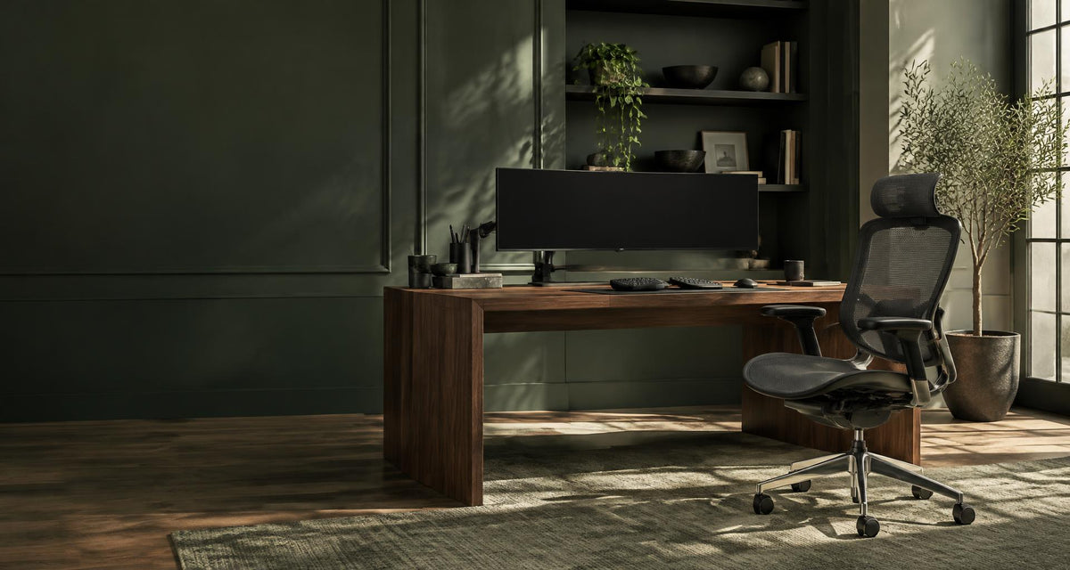 An ergonomic chair and walnut desk in a green home office